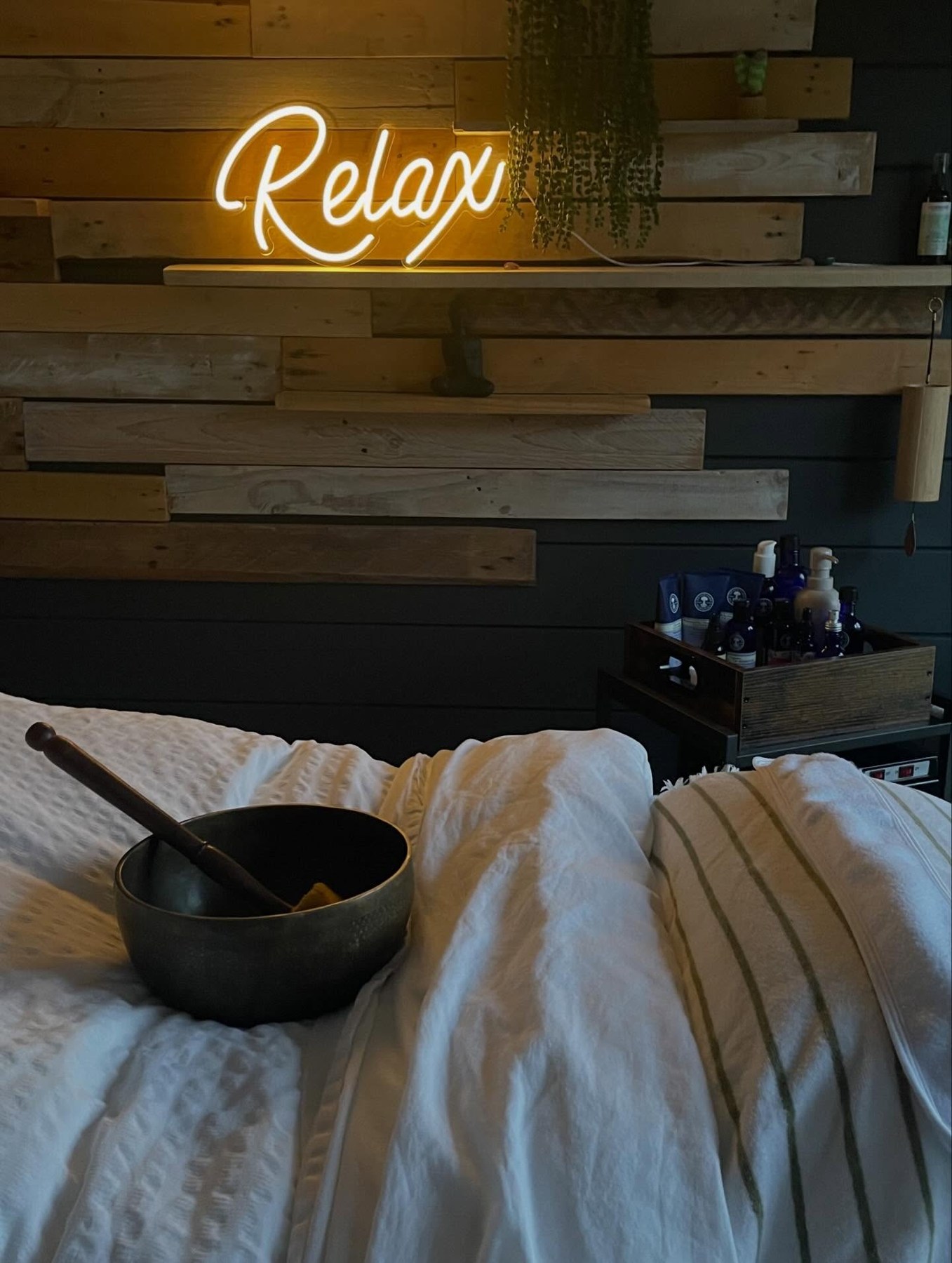 Soft treatment linens and skincare products in Claire’s wellness space
